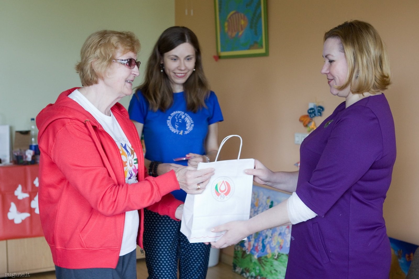 Foundation volunteer presenting charitable support to a community member